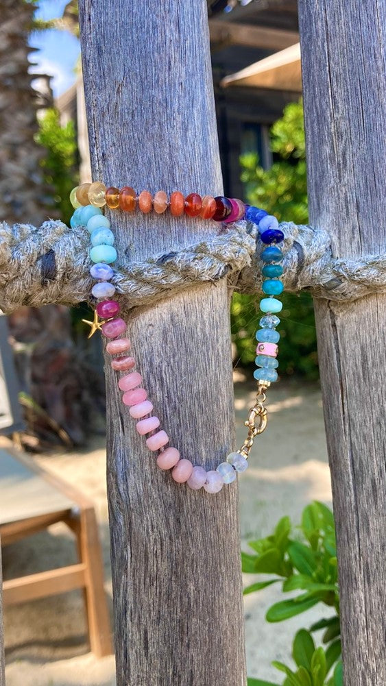 Rainbow gemstone necklace on beach