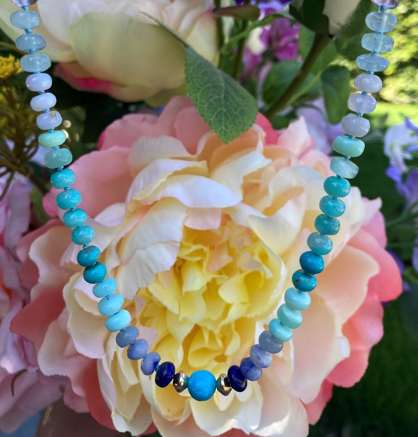 Beaded Turquoise and Opal Necklace near roses